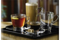 an assortment of four coffee glasses on a square plate 
