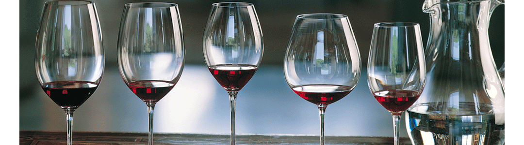 wine glasses in a row containing red wine